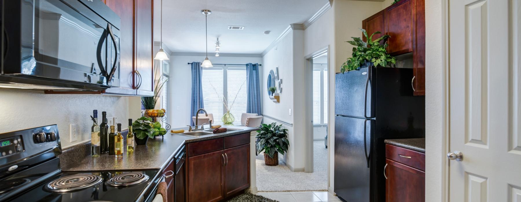 a kitchen with a black refrigerator