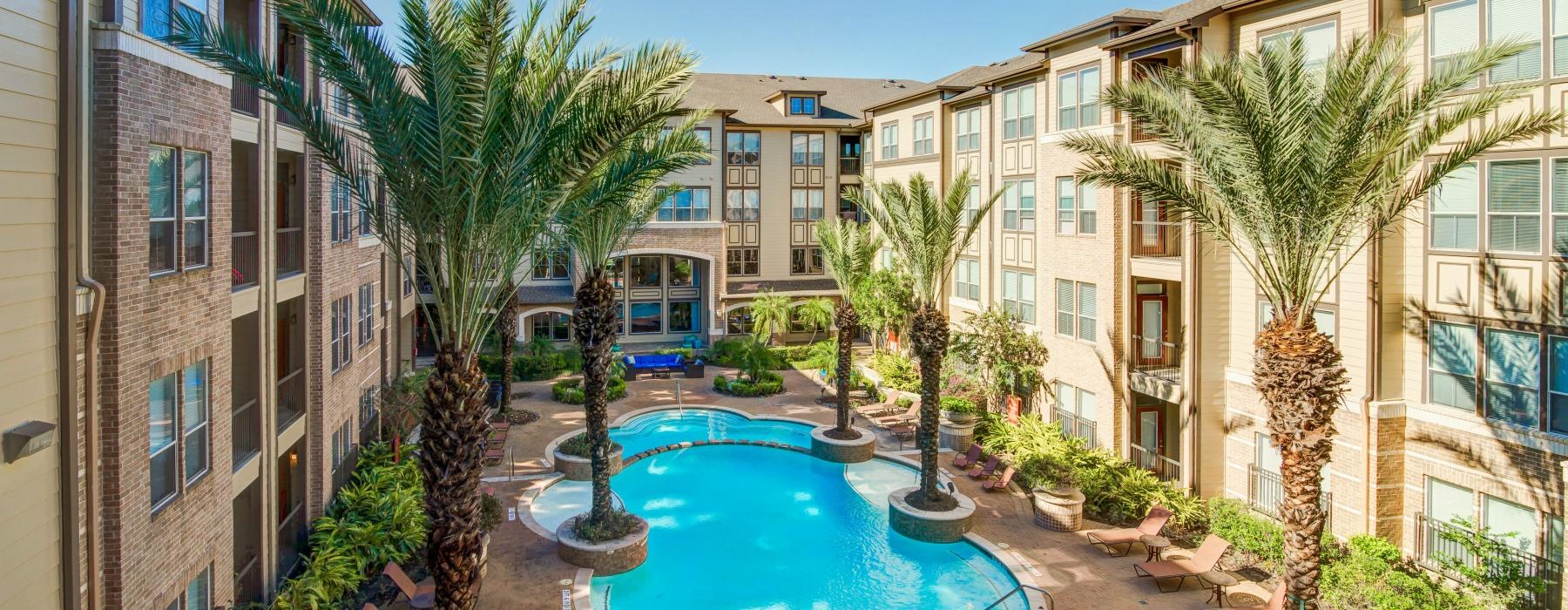 a pool in a courtyard between buildings
