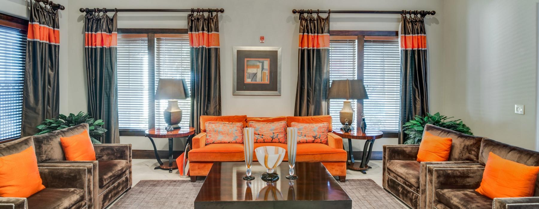 a living room with orange and white furniture