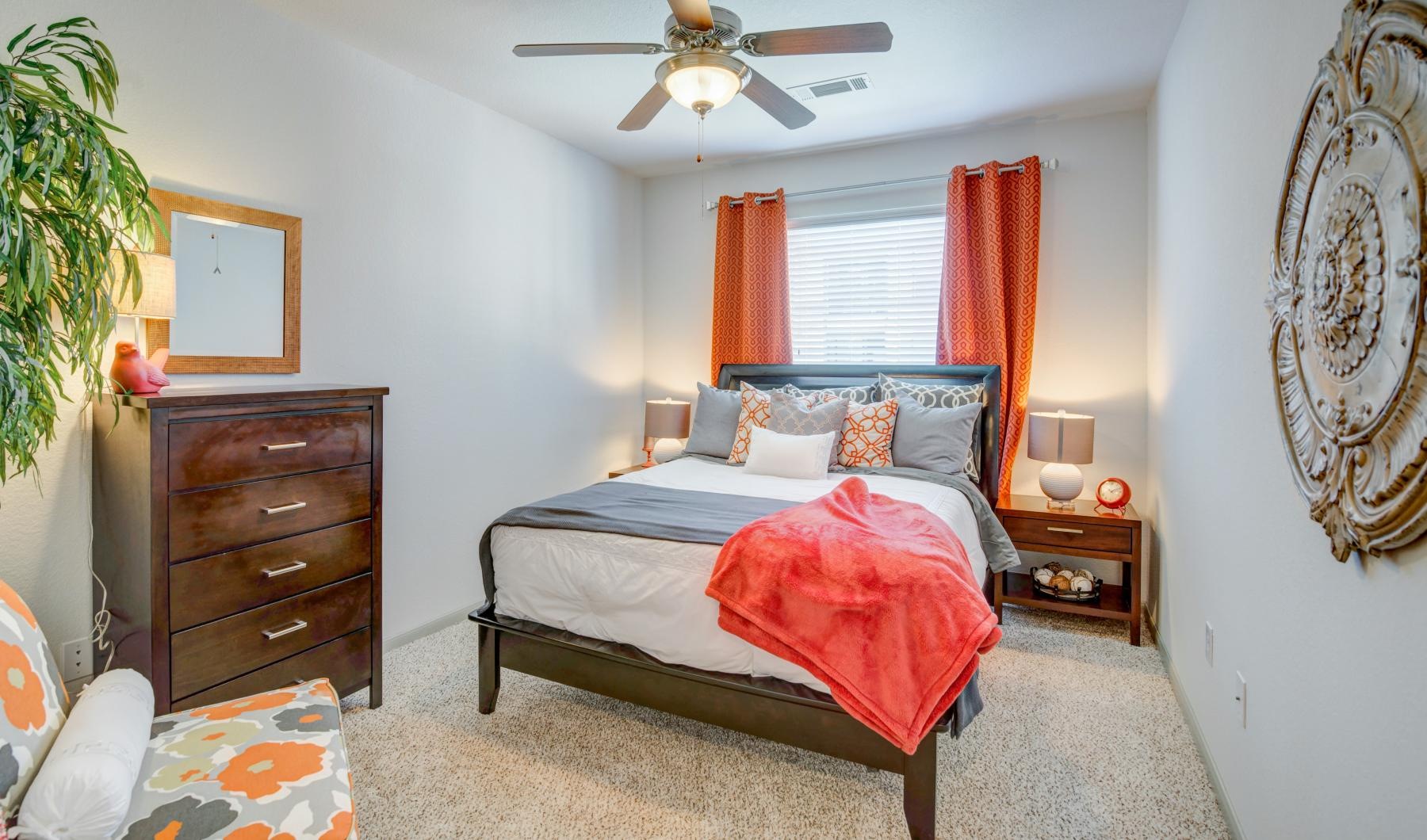 a bedroom with a bed and a fan