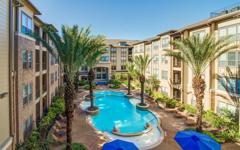 a pool in a courtyard between buildings