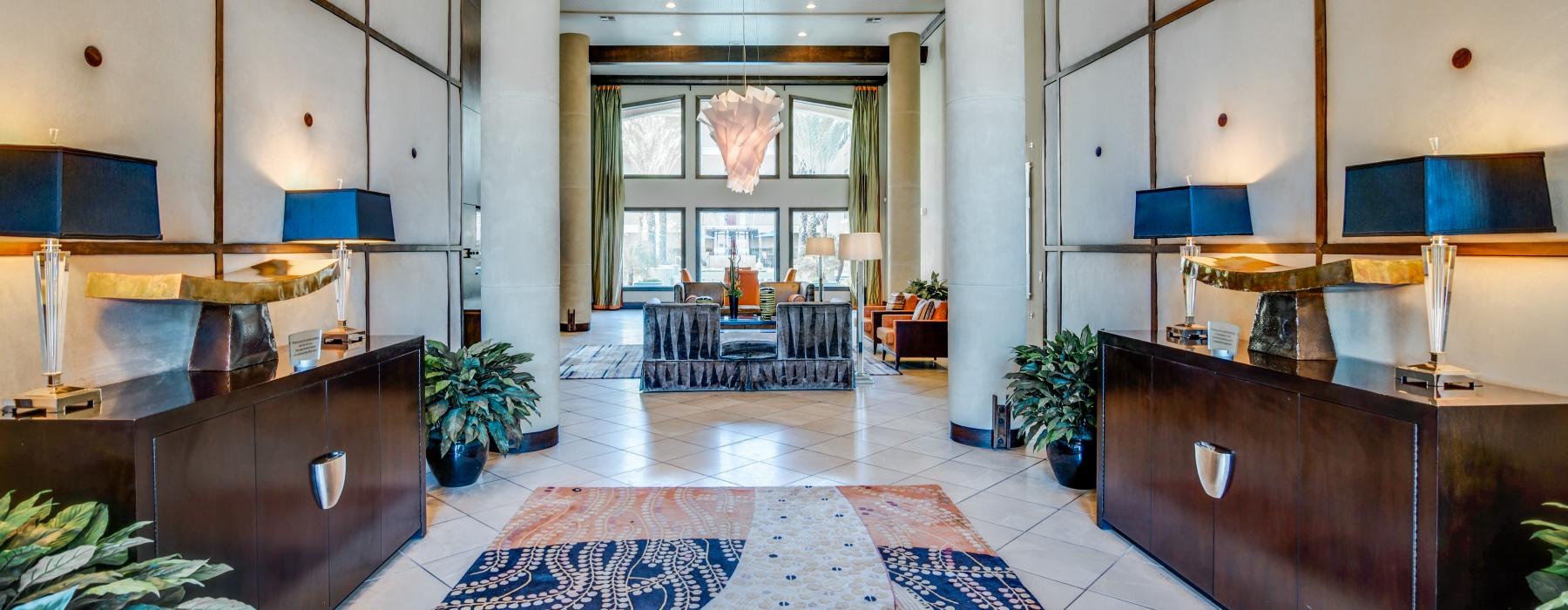 a room with a rug and a table with chairs and plants